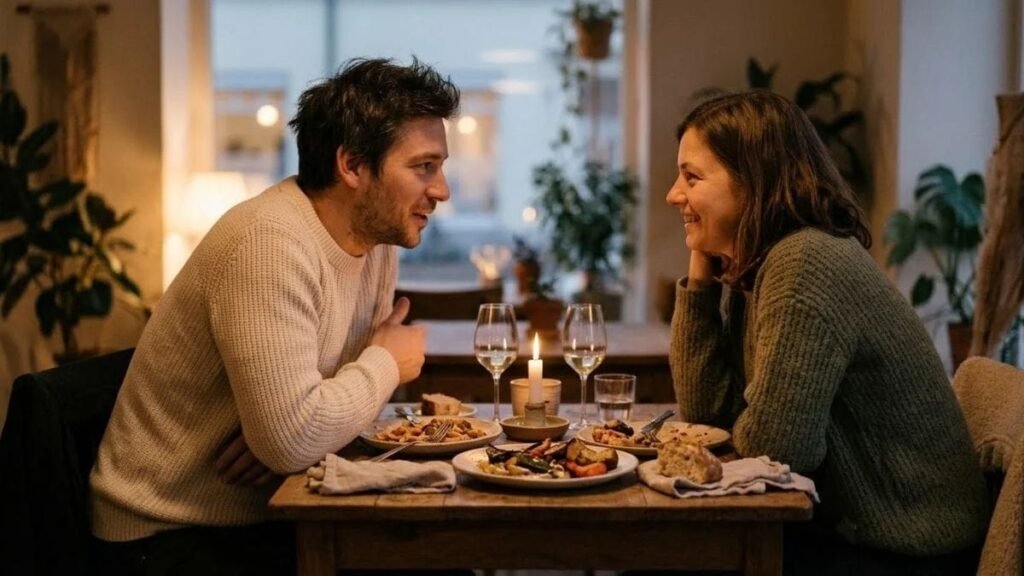 Couple talking over dinner at a home table about questions to ask your partner