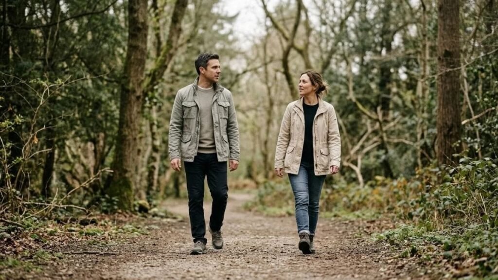 Two adults walking a trail and talking